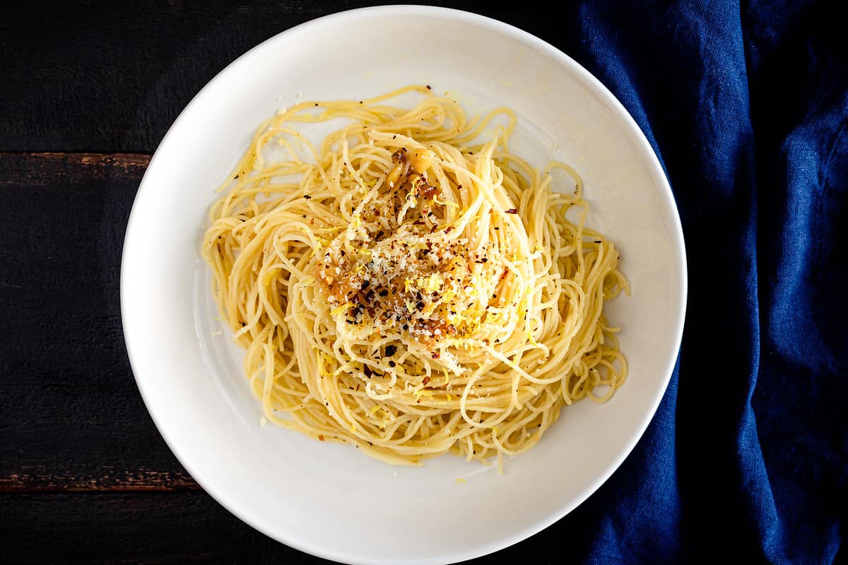 Angel hair pasta noodles with roasted garlic, parmesan cheese, lemon zest, and red pepper flakes