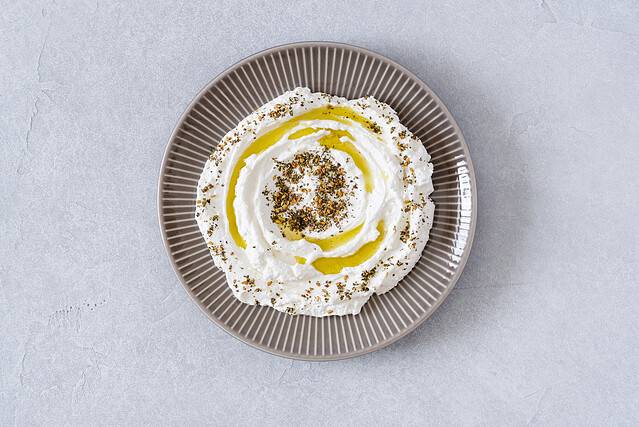 Labneh yogurt, cream cheese with olive oil and zaatar . Traditional middle eastern arabic breakfast dip.Top view