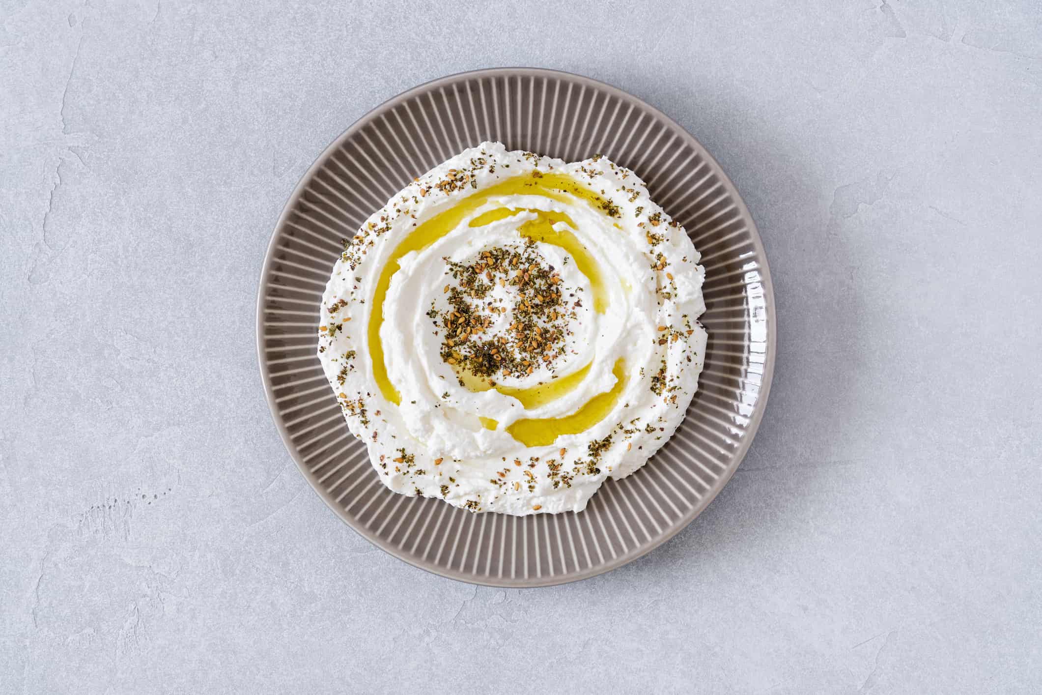 Labneh yogurt, cream cheese with olive oil and zaatar . Traditional middle eastern arabic breakfast dip.Top view