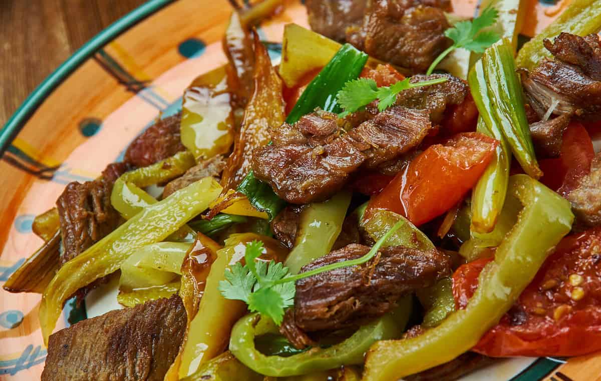 Ker-u-sus , Armenian cuisine, dish made with fried beef skirt steak and peppers,Traditional assorted dishes, Top view.
