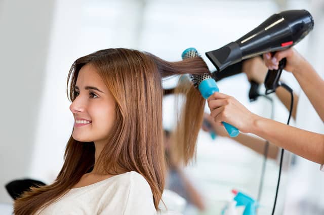 Portrait of a happy woman at the hair salon