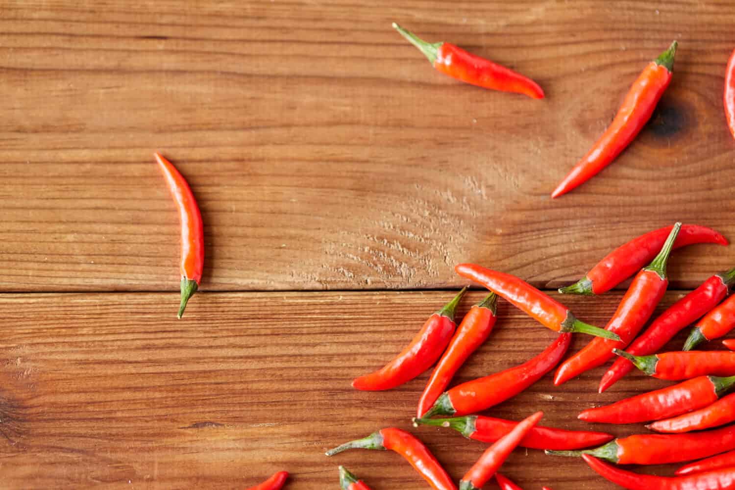 cooking, food and culinary concept - red chili or cayenne pepper on wooden boards