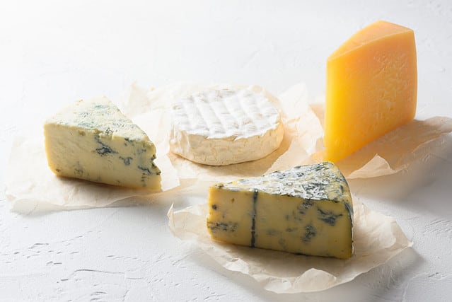 Cheese : yellow Maasdam, white Camembert and blue cheese Dor Blue on white background. Copy space. Concept serving cheese.
