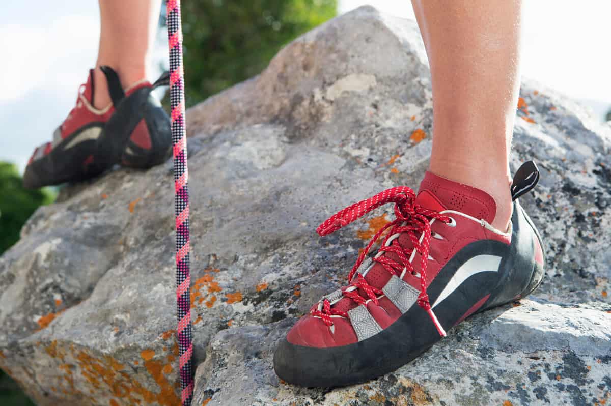 Close-up shot of a female's feet in rock climbing shoes.