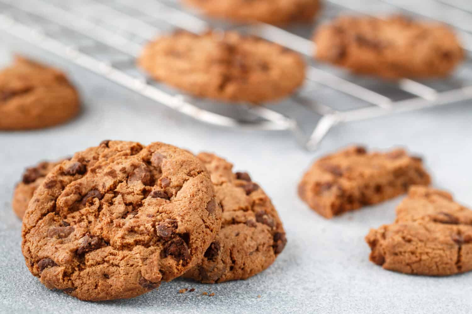 Freshly baked homemade crunchy cookies with chocolate chips, peanut butter or salted caramel. A delicious treat for gourmets. Biscuits close-up. Selective focus, shallow depth of field