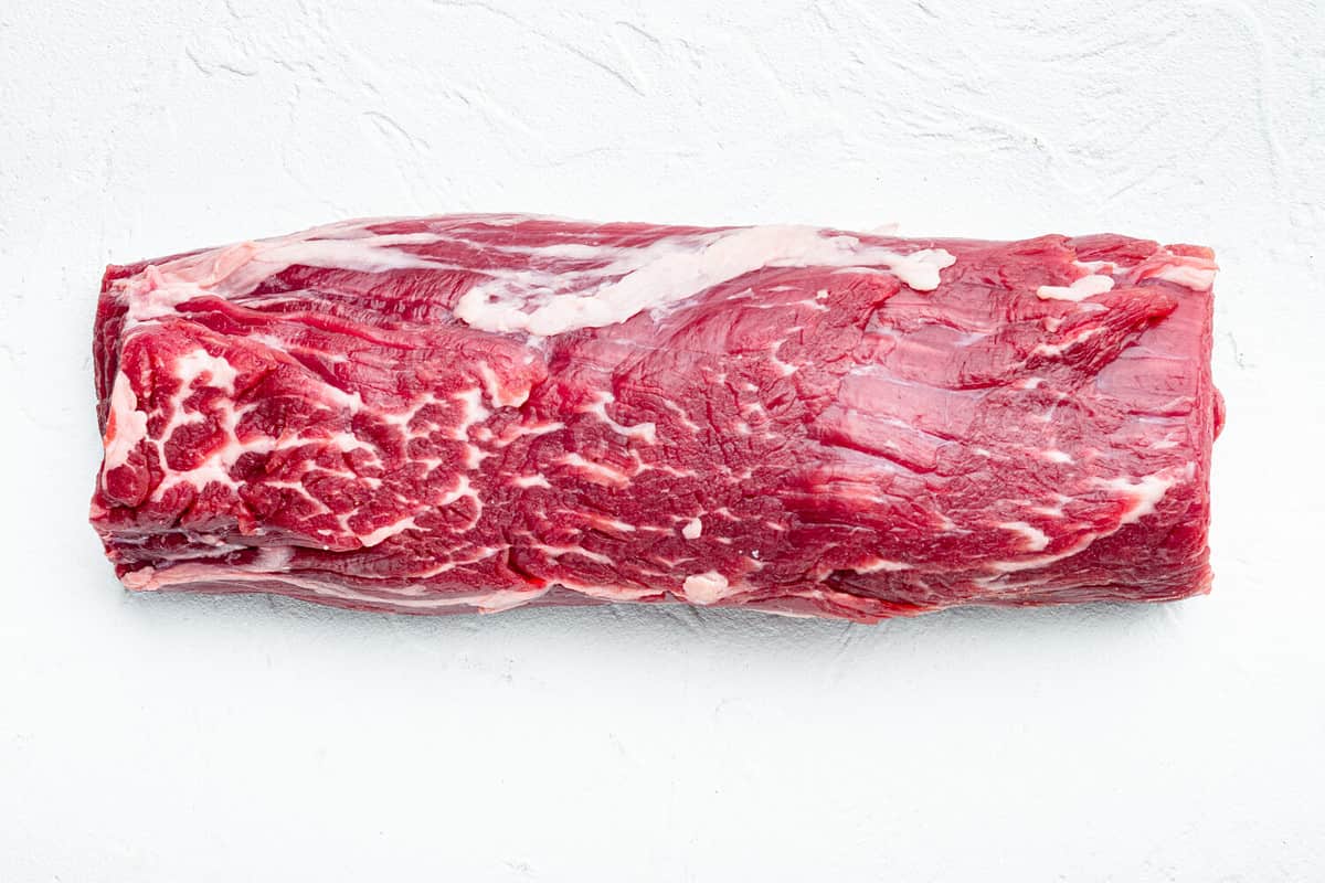 Tenderloin, or Eye Fillet cut raw marbled beef meat set, on white stone background, top view flat lay