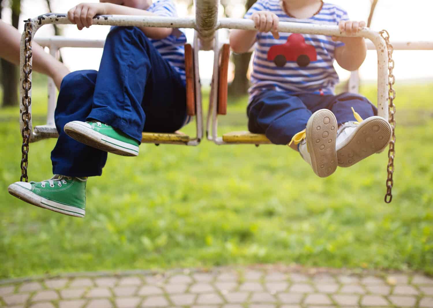 Two cute little boys on an old carousel.