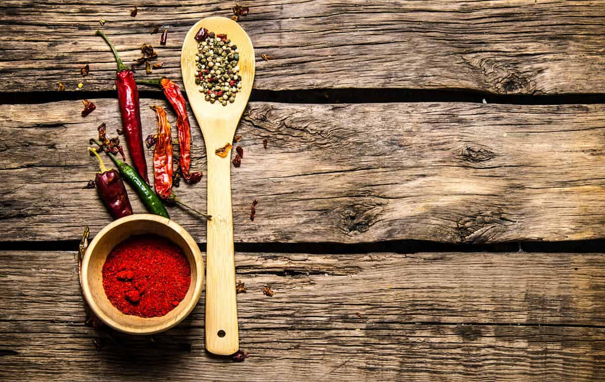 Aromatic spices and herbs on a rustic background. On wooden background. Free space for text . Top view