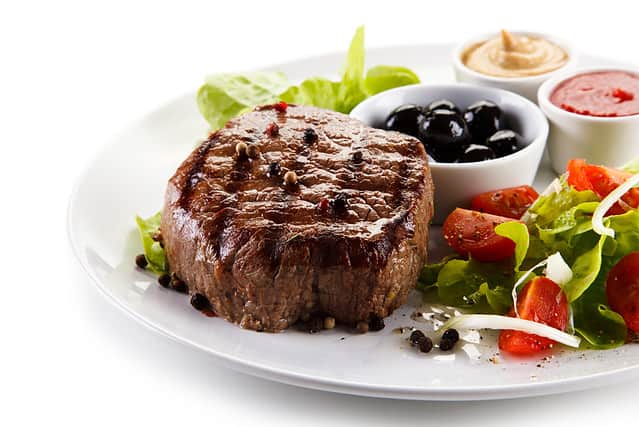 Grilled steak on white plate