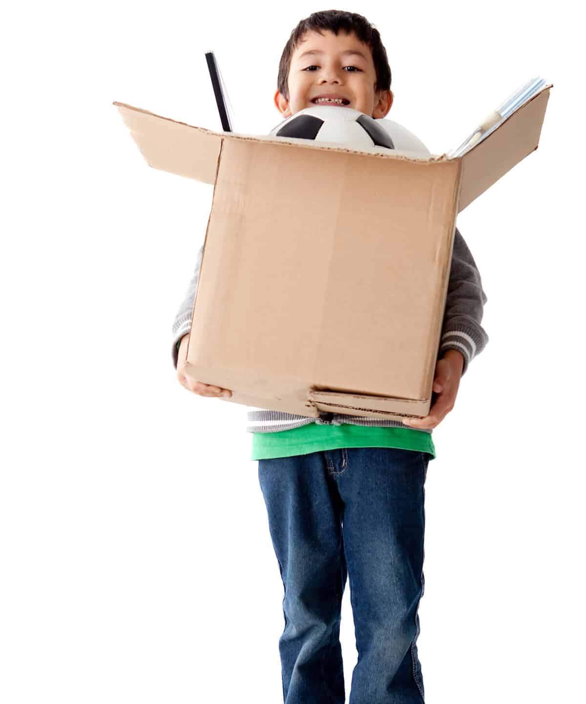 Boy holding a box with toys â?? isolated over a white background