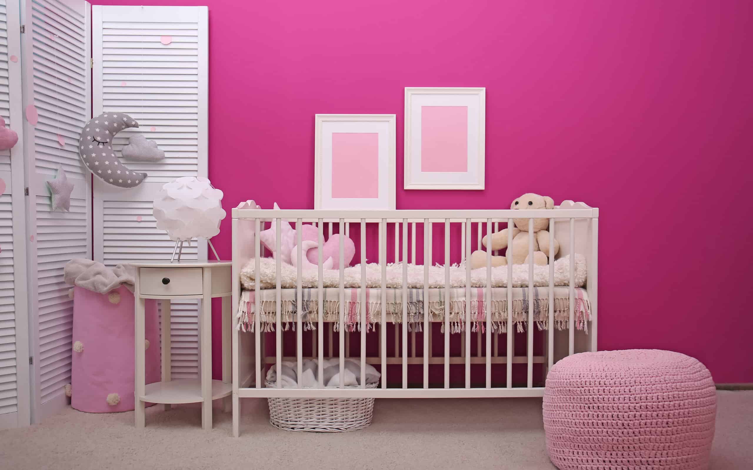 Baby room interior with crib near color wall