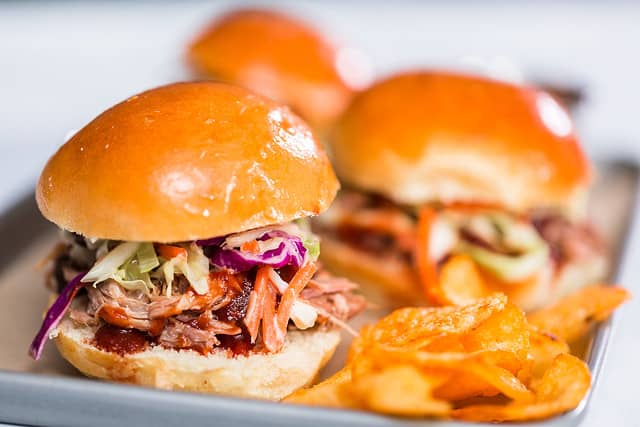 BBQ pulled pork sandwich in shape of small sliders with brioche buns.