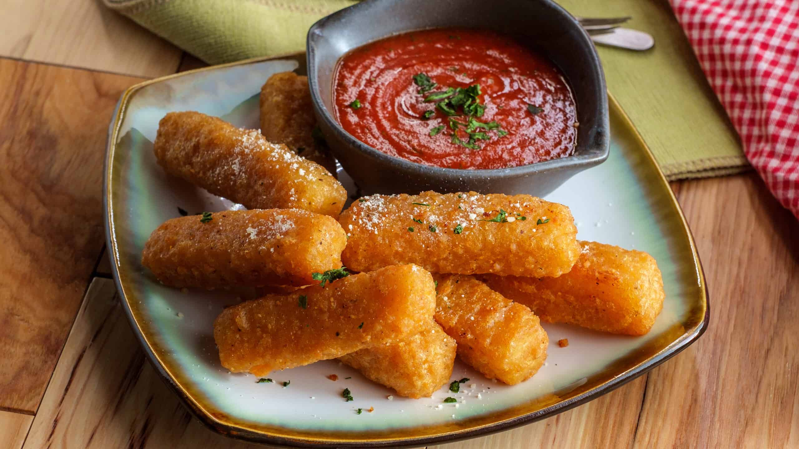 Breaded fried mozzarella cheese sticks with tomato marinara dipping sauce