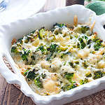 Baked broccoli with chicken in a ceramic form on a wooden table