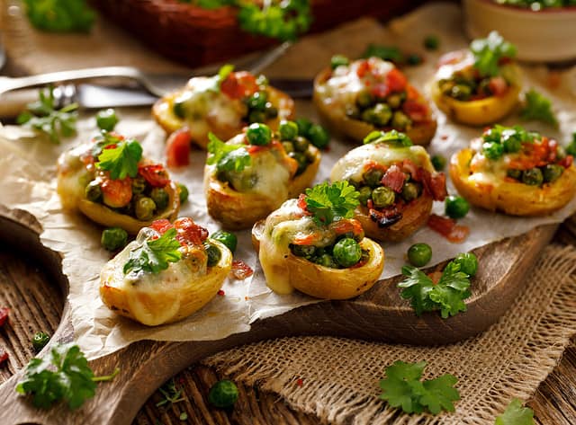 Baked potatoes stuffed with green peas, cheese and bacon