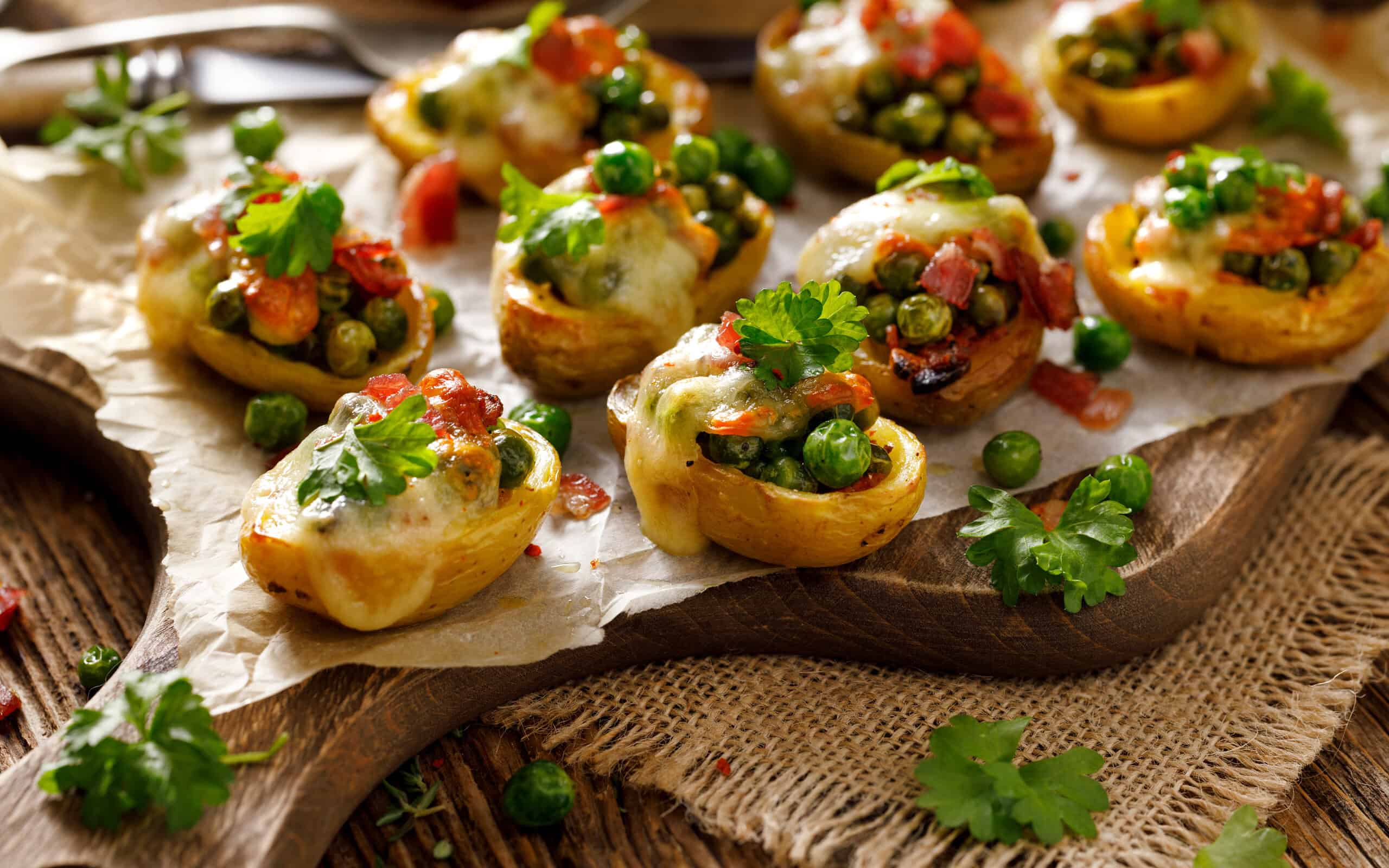 Baked potatoes stuffed with green peas, cheese and bacon
