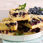 Blueberry crumble topping coffeecake, sliced on plate
