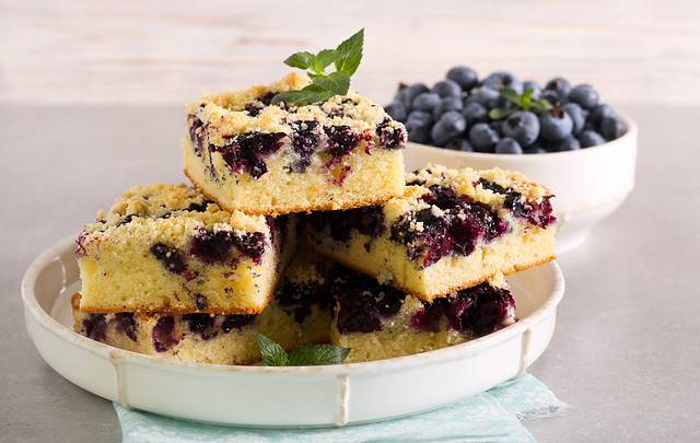 Blueberry crumble topping coffeecake, sliced on plate