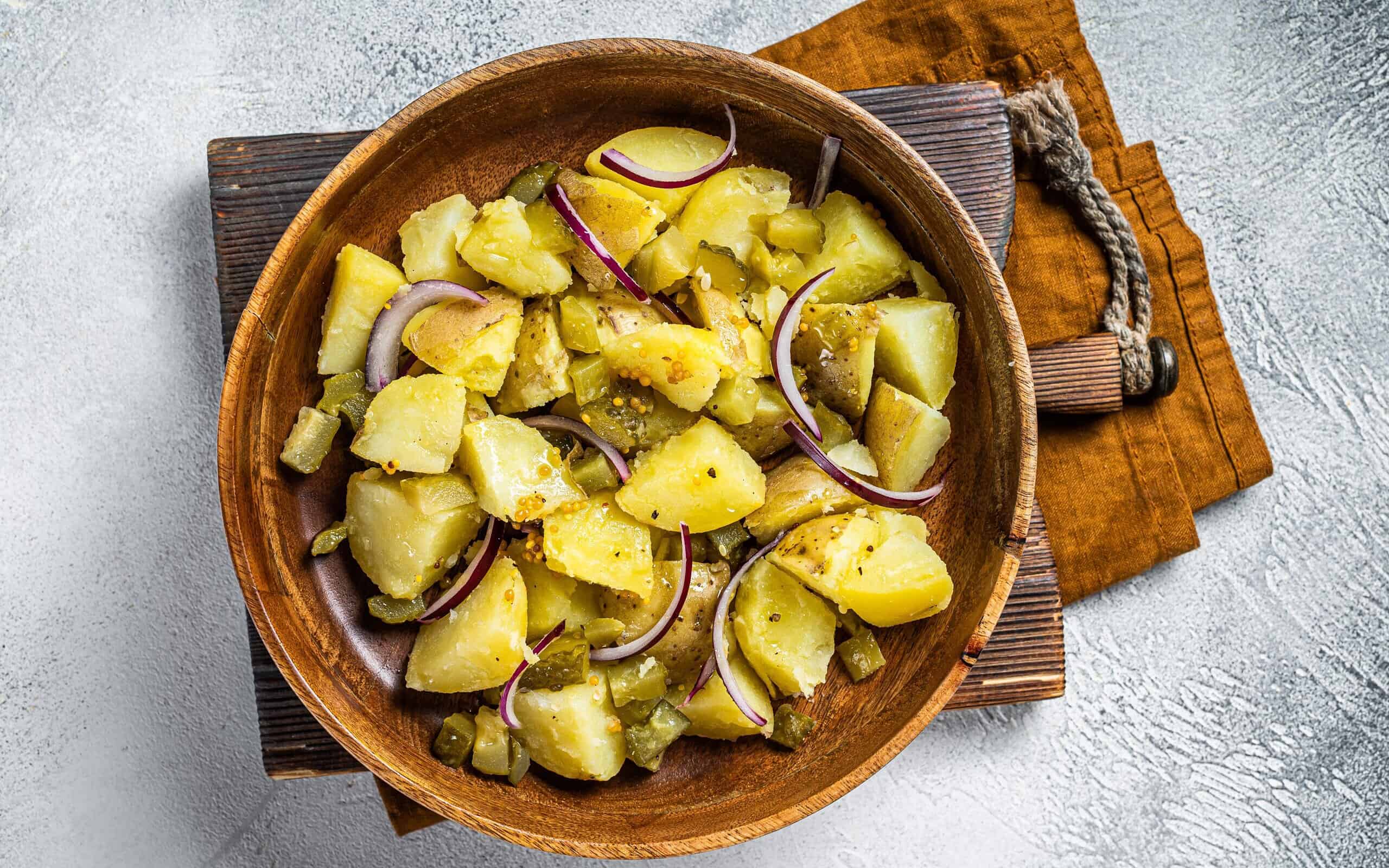 Bowl of warm potato salad with bacon, German Kartoffelsalat