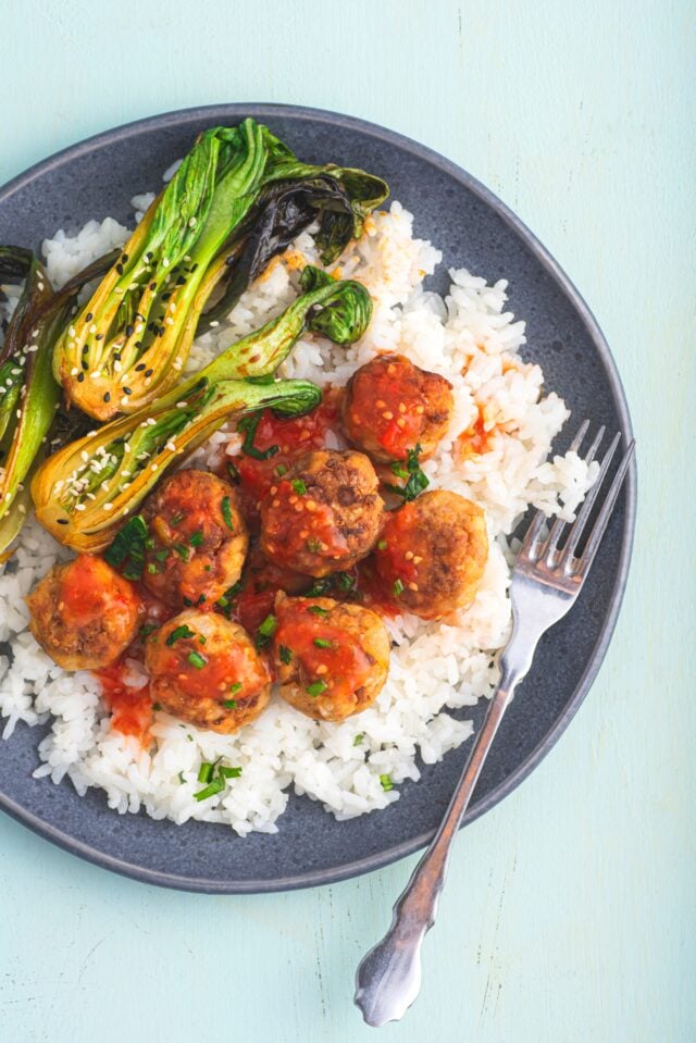 Bowl of chicken meatballs in sweet chili sauce with rice
