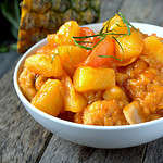 Sweet and sour chicken with pineapple and tomatoes.