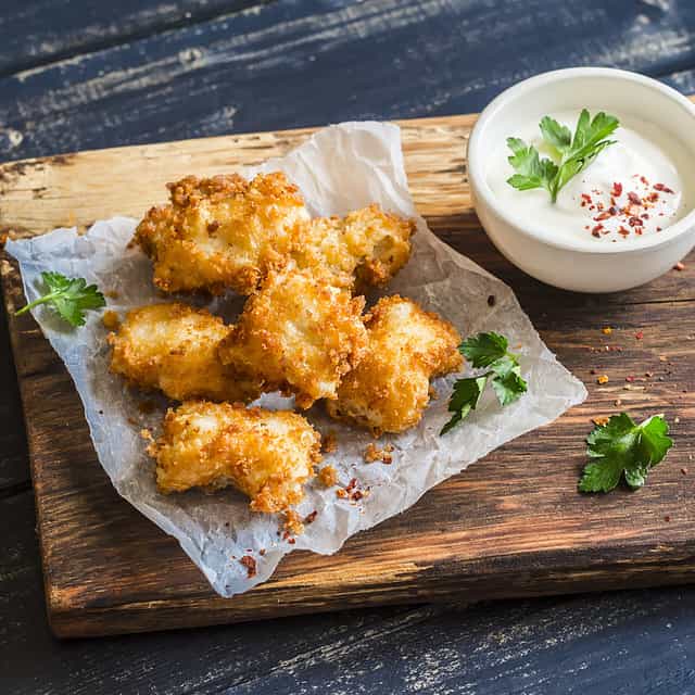 Crispy fried fish on a wooden rustic board