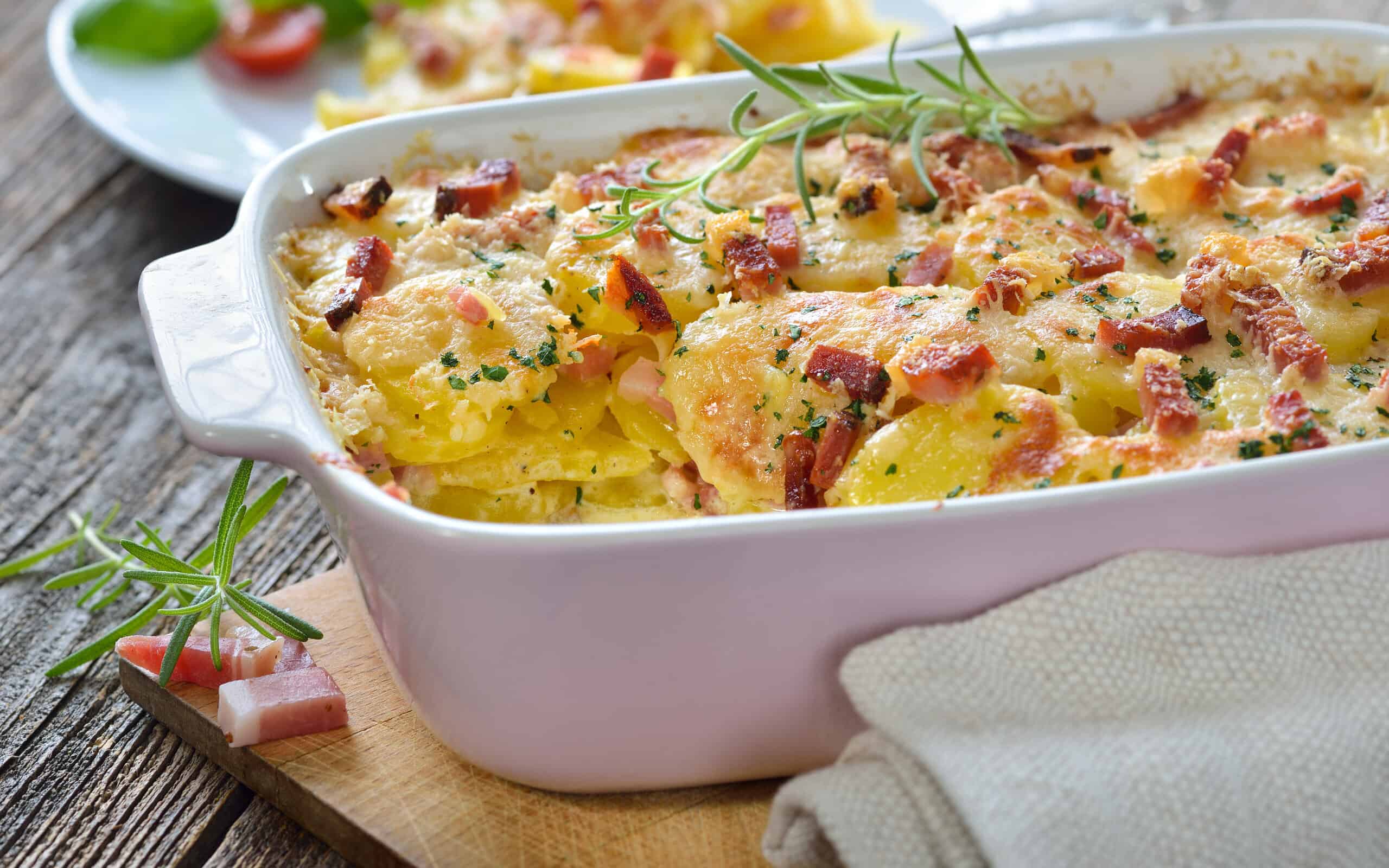 Potato gratin with parmesan cheese, cream and delicious cured bacon