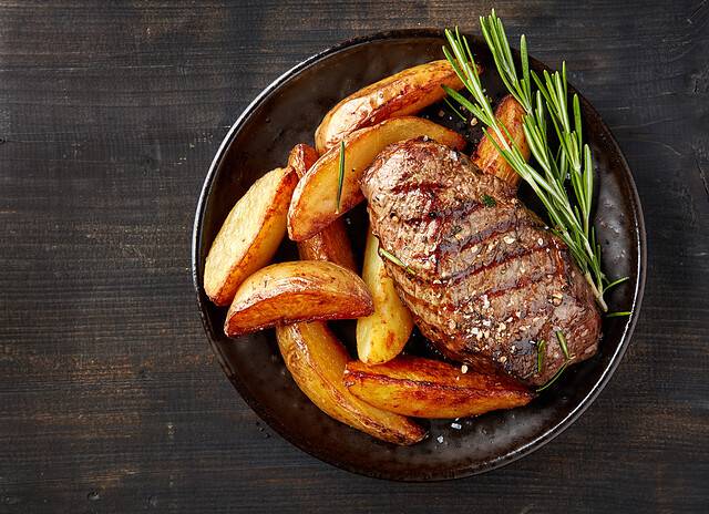 grilled beef steak and potatoes