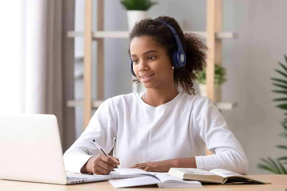 A young high school pupil taking online classes.