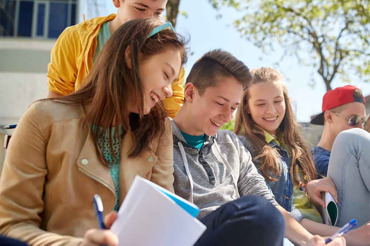 A group of students seated outside class.