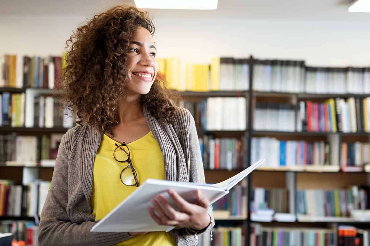 Photo of a university student at the library.