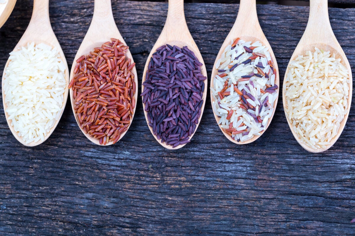 Five kinds of rice on wooden spoon.