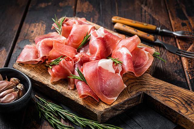 Slices of jamon serrano ham and prosciutto
