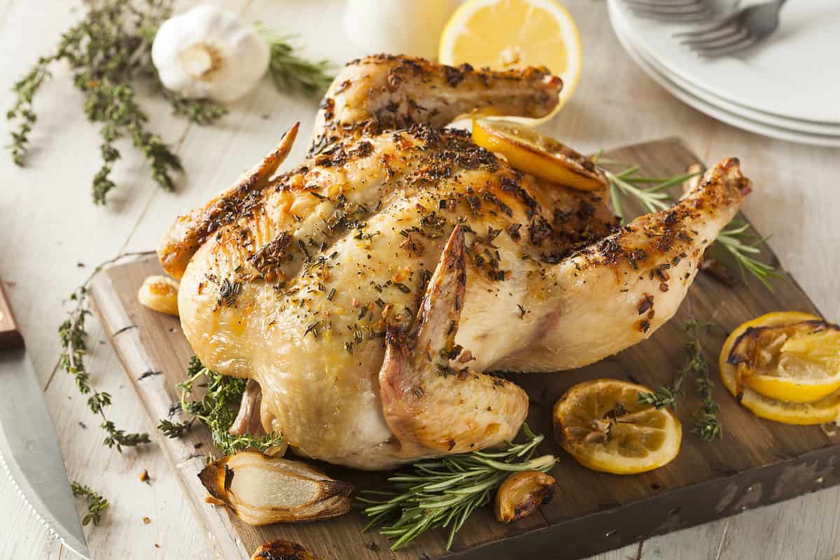 Homemade Lemon and Herb Whole Chicken on a Cutting Board
