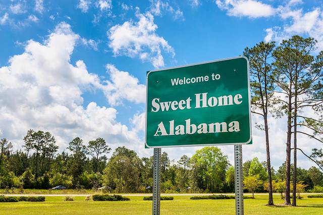 Welcome to Sweet Home Alabama Road Sign along Interstate 10 in Robertsdale, Alabama USA, near the State Border with Florida.