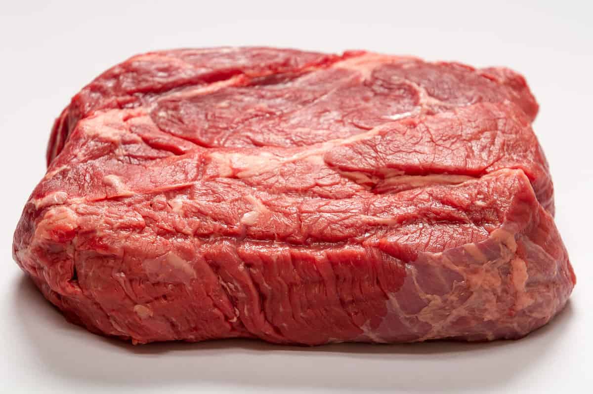 Horizontal Photo of Raw Beef Roast On White Background with marbling