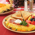 A Western Omelet with fresh fruit and berries for breakfast