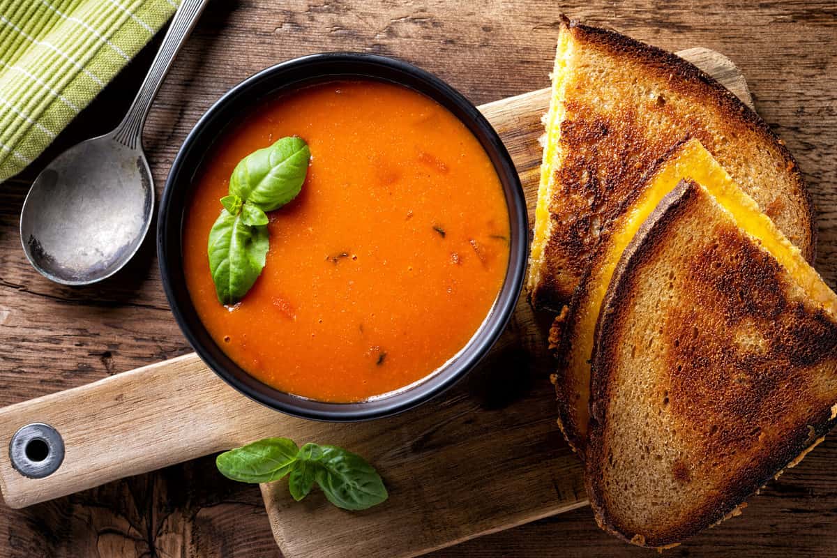 Delicious homemade tomato soup with a grilled cheese sandwich on rye.