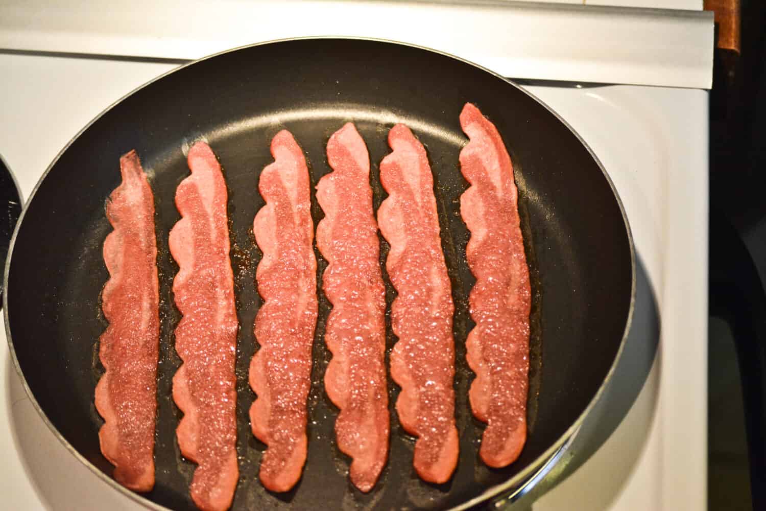 Turkey bacon in frying pan