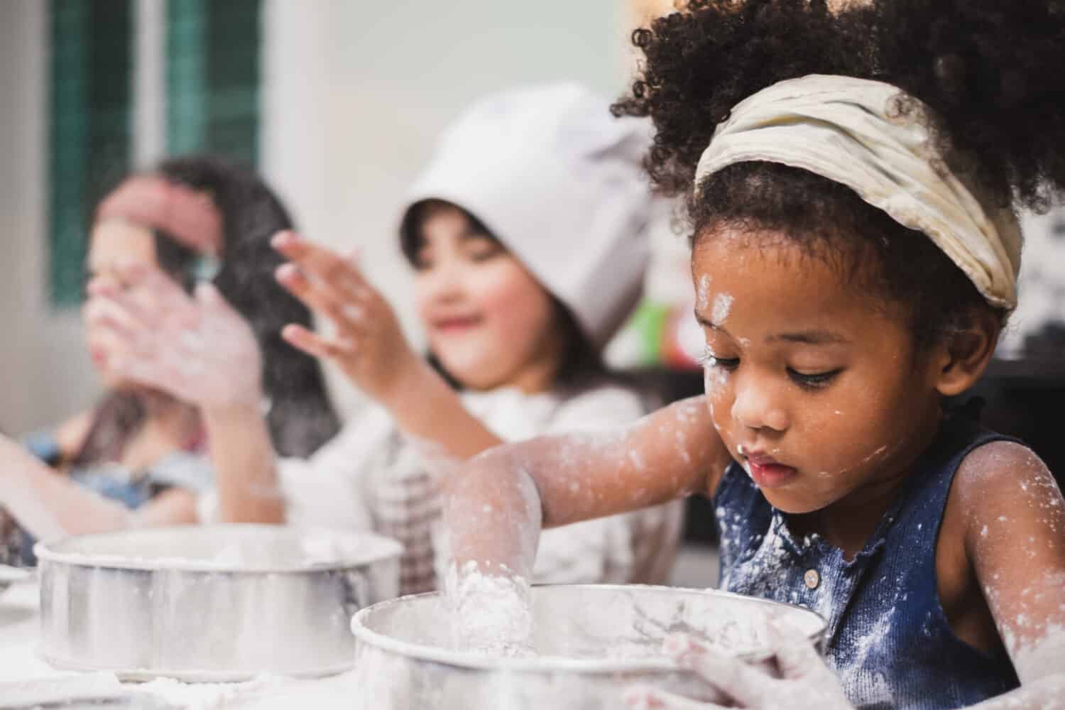 Group diversity kids girl making cake bakery in kitchen