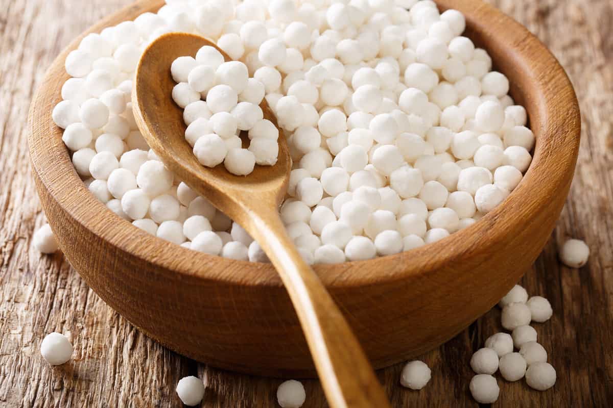 Organic tapioca pearls close-up in a bowl on a wooden table. horizontal