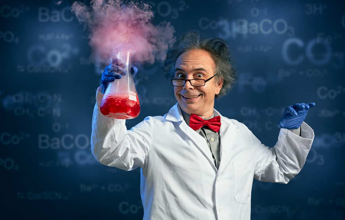 Happy chemist holding test tube with his successful experiment