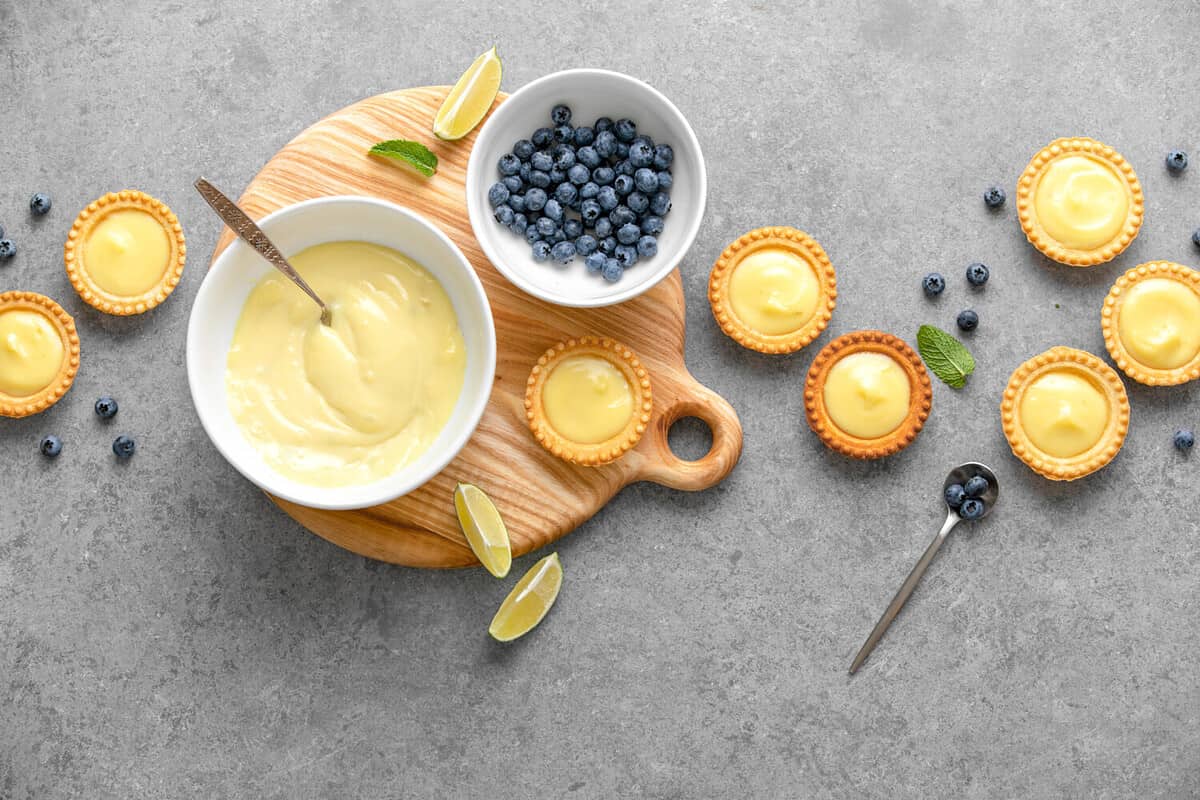 Tartlets with custard and blueberry, top down view, blank space for a text