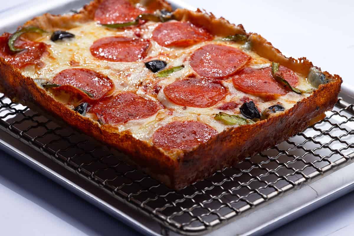 detroit pizza on an iron tray. selective focus