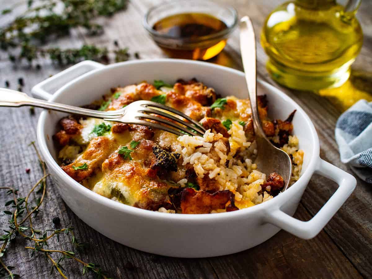 Rice casserole with barbecue chicken breast, cheese and vegetables
