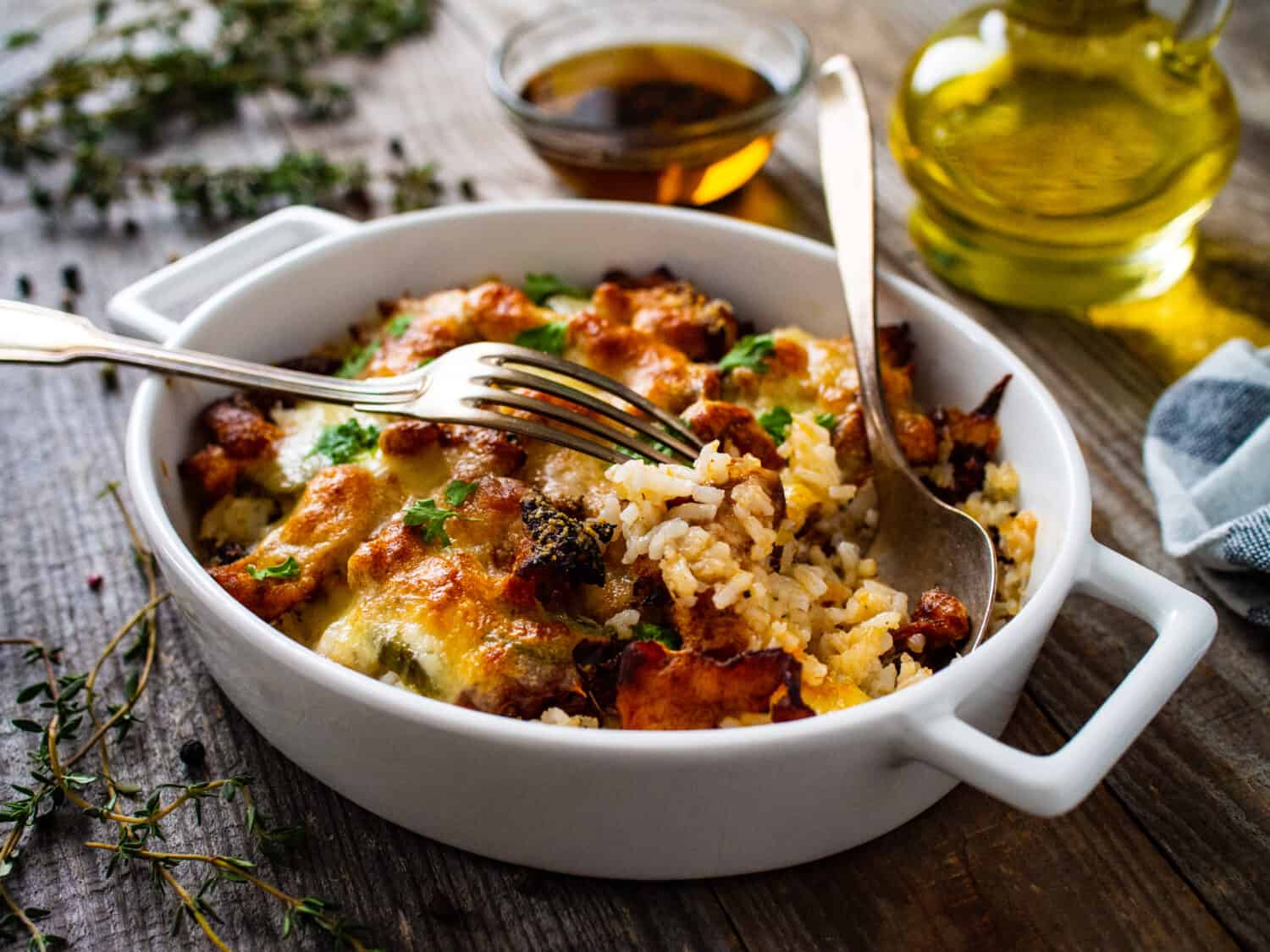 Rice casserole with barbecue chicken breast, cheese and vegetables 