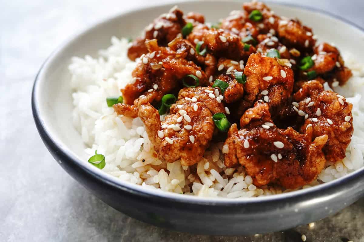 Homemade sesame Chicken served with Jasmine white rice, selective focus
