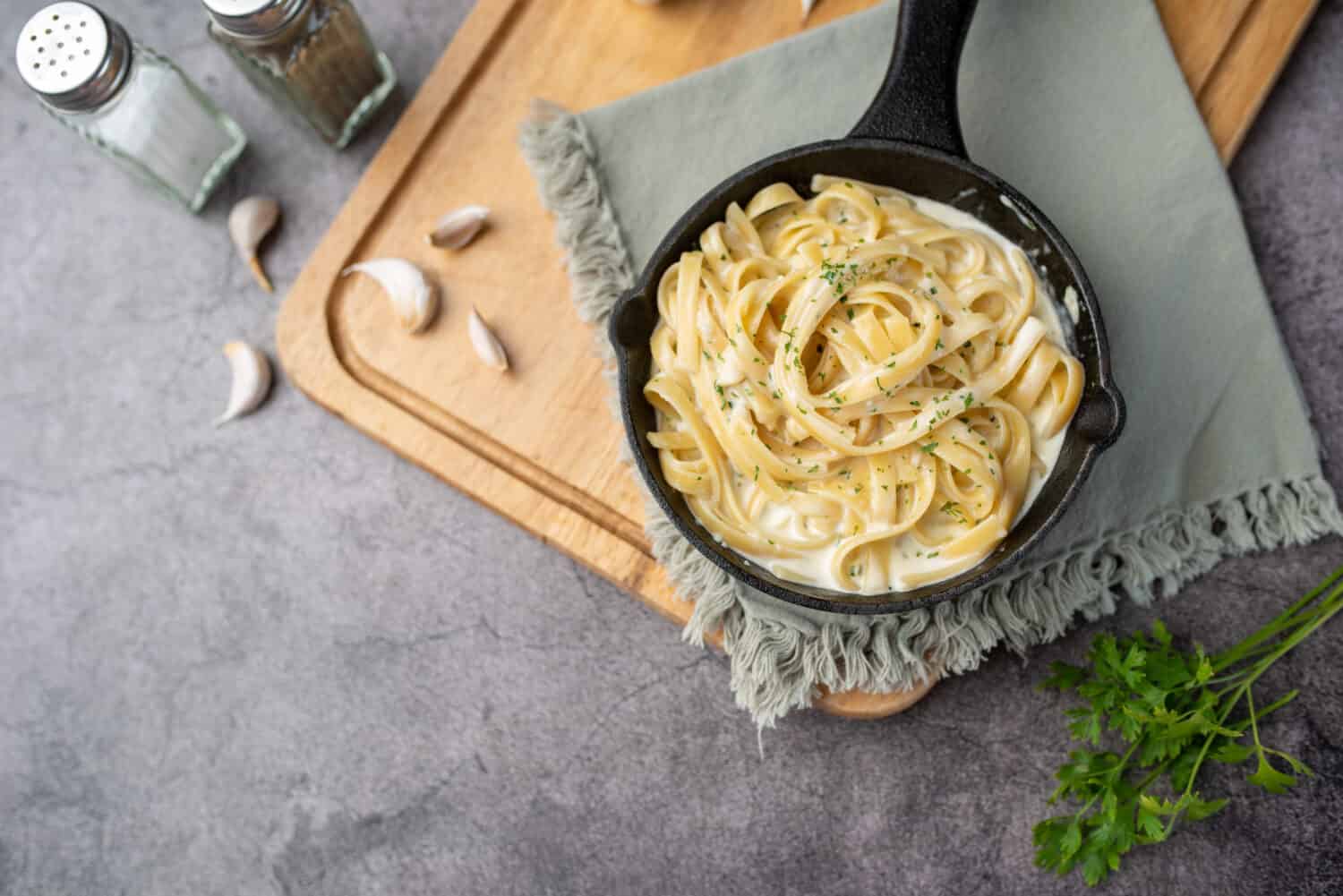 Alfredo pasta dinner with creamy white sauce and herbs
