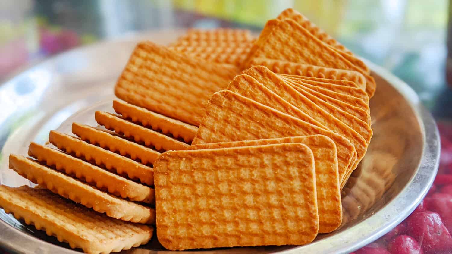 Wheat biscuits vs. cookie in the steel plate with blury background. Indian biscuits popularly known as Chai-biscuit in India