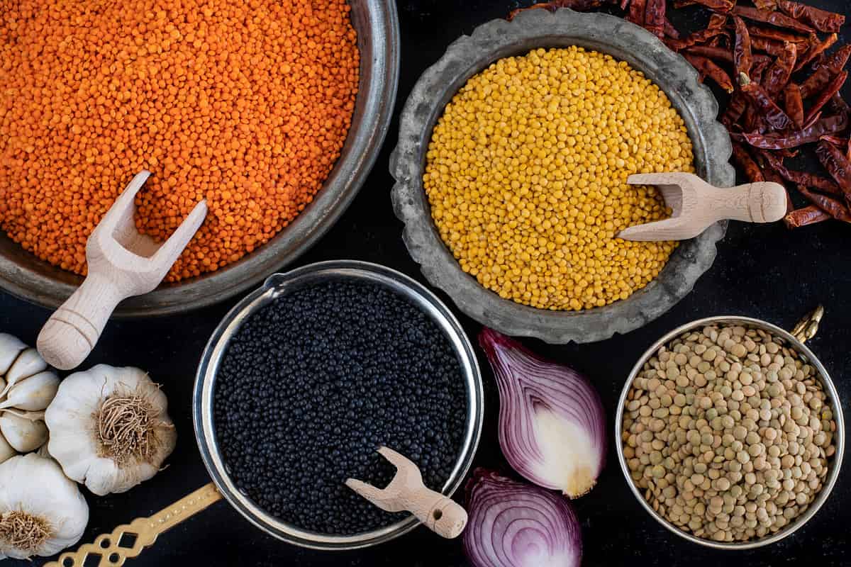 Various of organic lentils on the wooden table. Dried lentils and legumes concept in the bowl